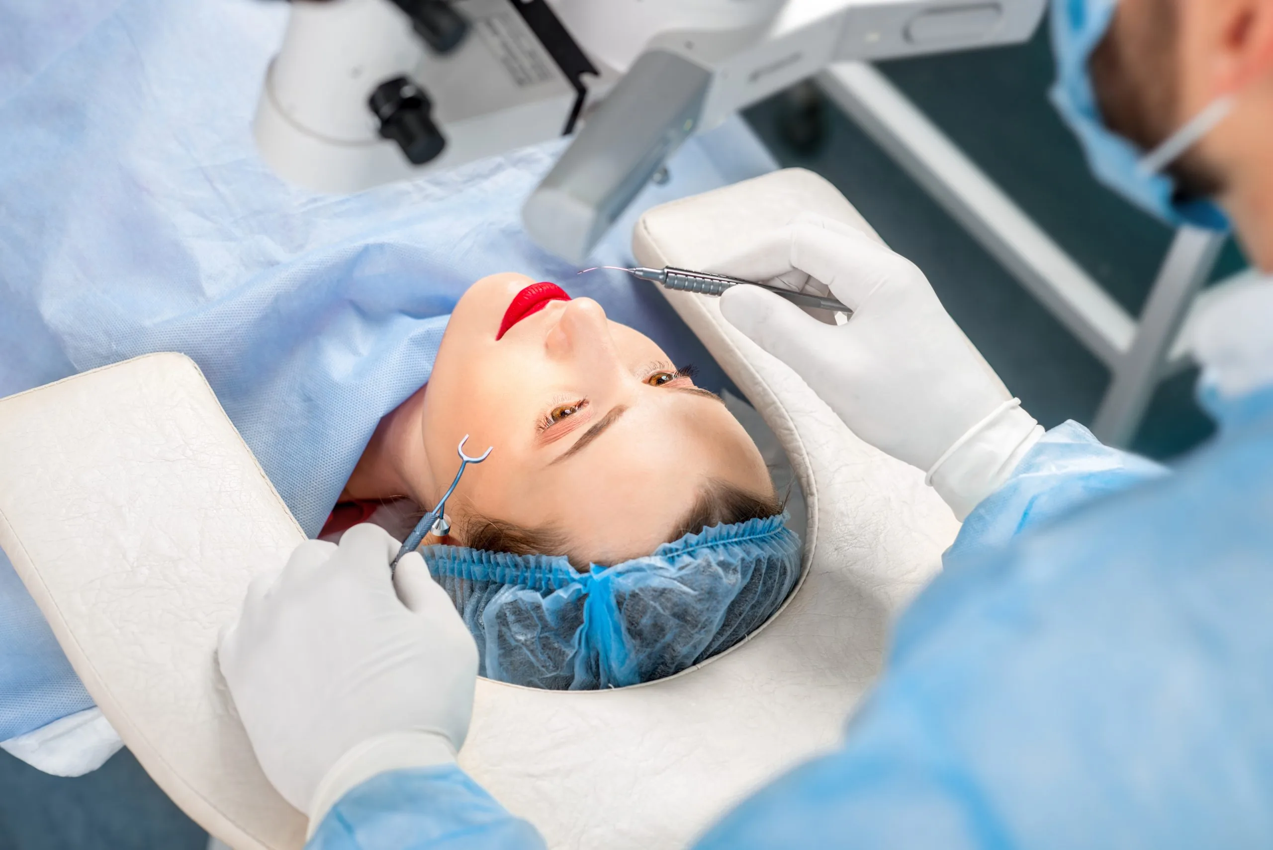 Surgion operating eye of female patient with surgical tools in the operating room