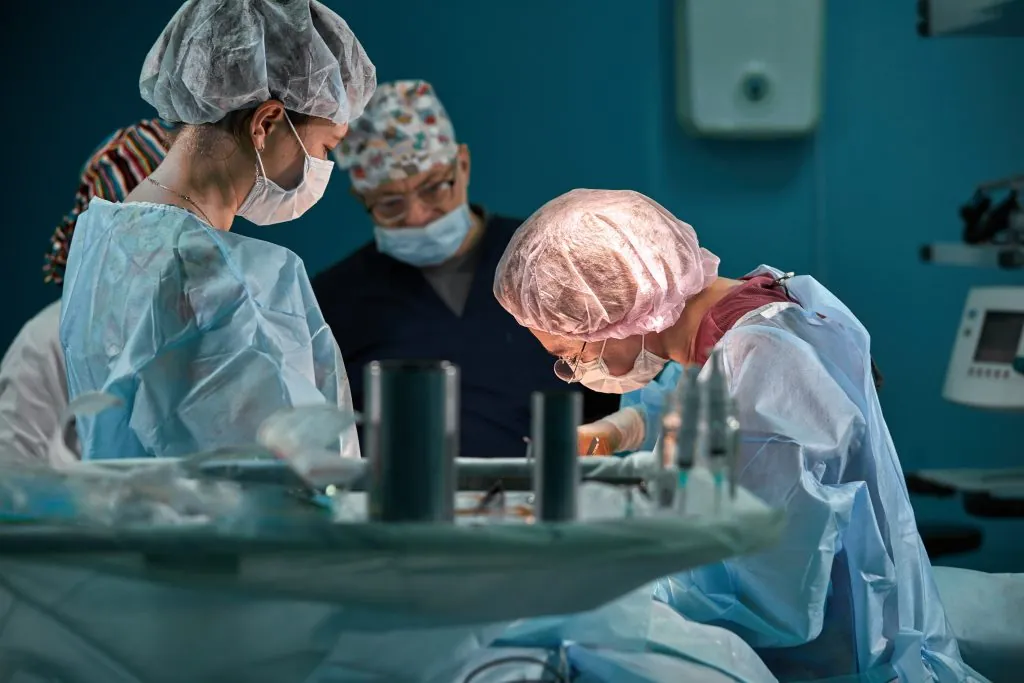 Group of surgeons in operating theater. Medical team performing surgery in operation room