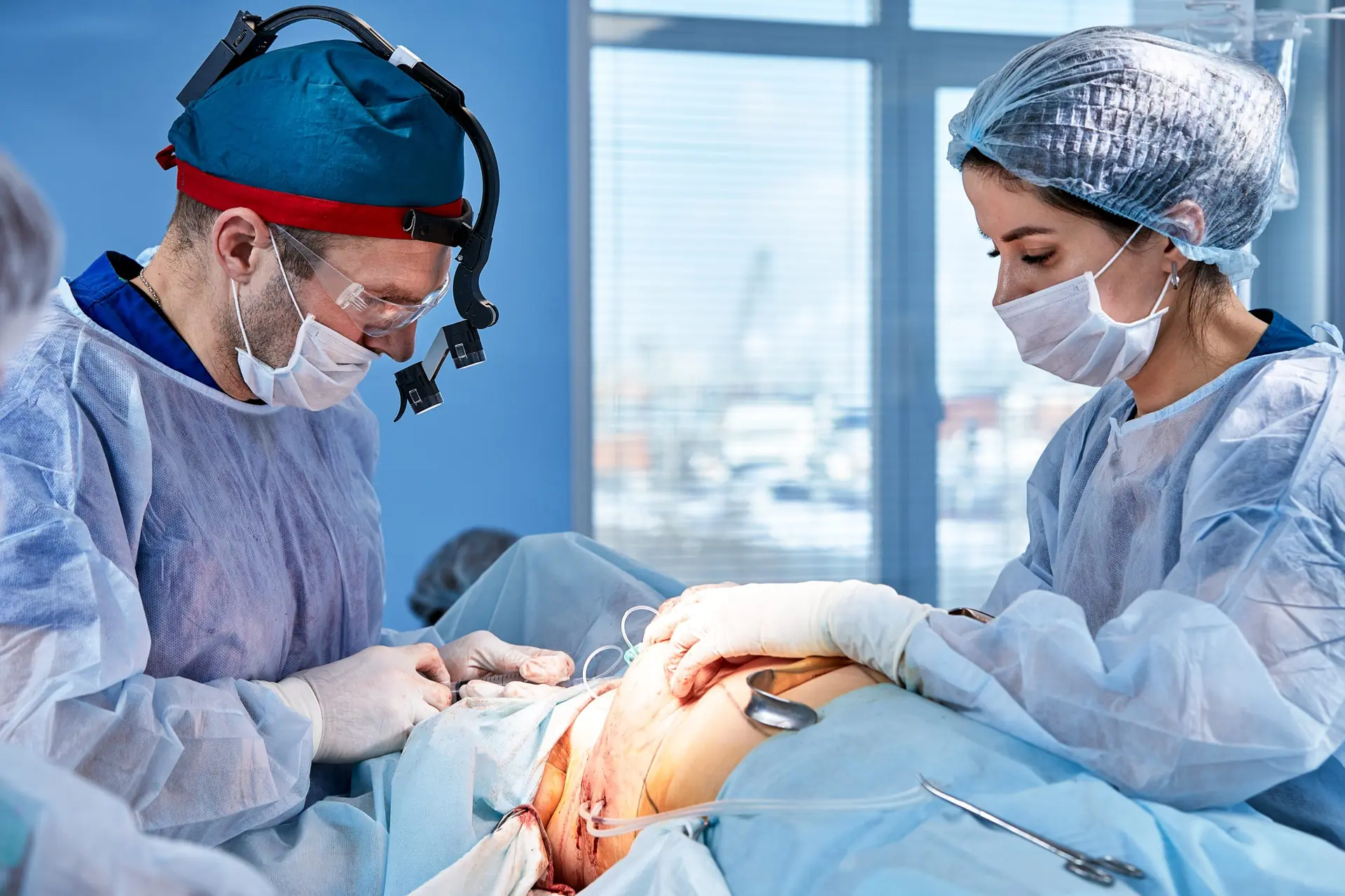 The doctor performs an operation to reconstruct the female breast. Close-up of plastic surgeon performing implantation procedure, breast cancer.